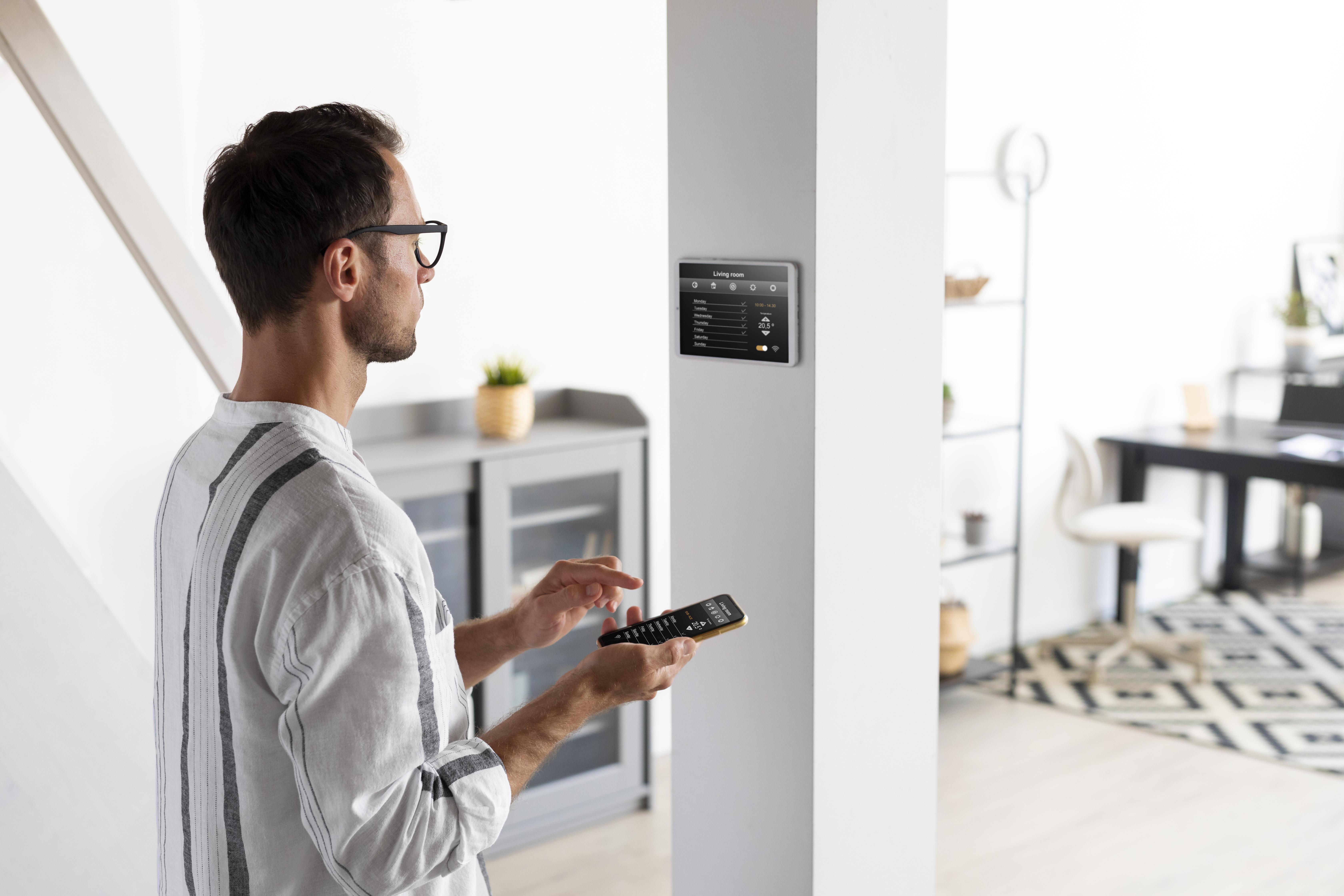 Person using smartphone in automated home